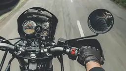 Rider point of view from motorcycle handlebars on the road