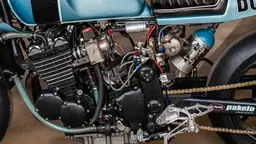 Drag bike engine closeup showing the modified motor in a workshop