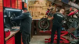 Mechanic working on motorcycles in a tuning workshop