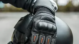 Motorcycle helmet and riding gloves resting on a bike